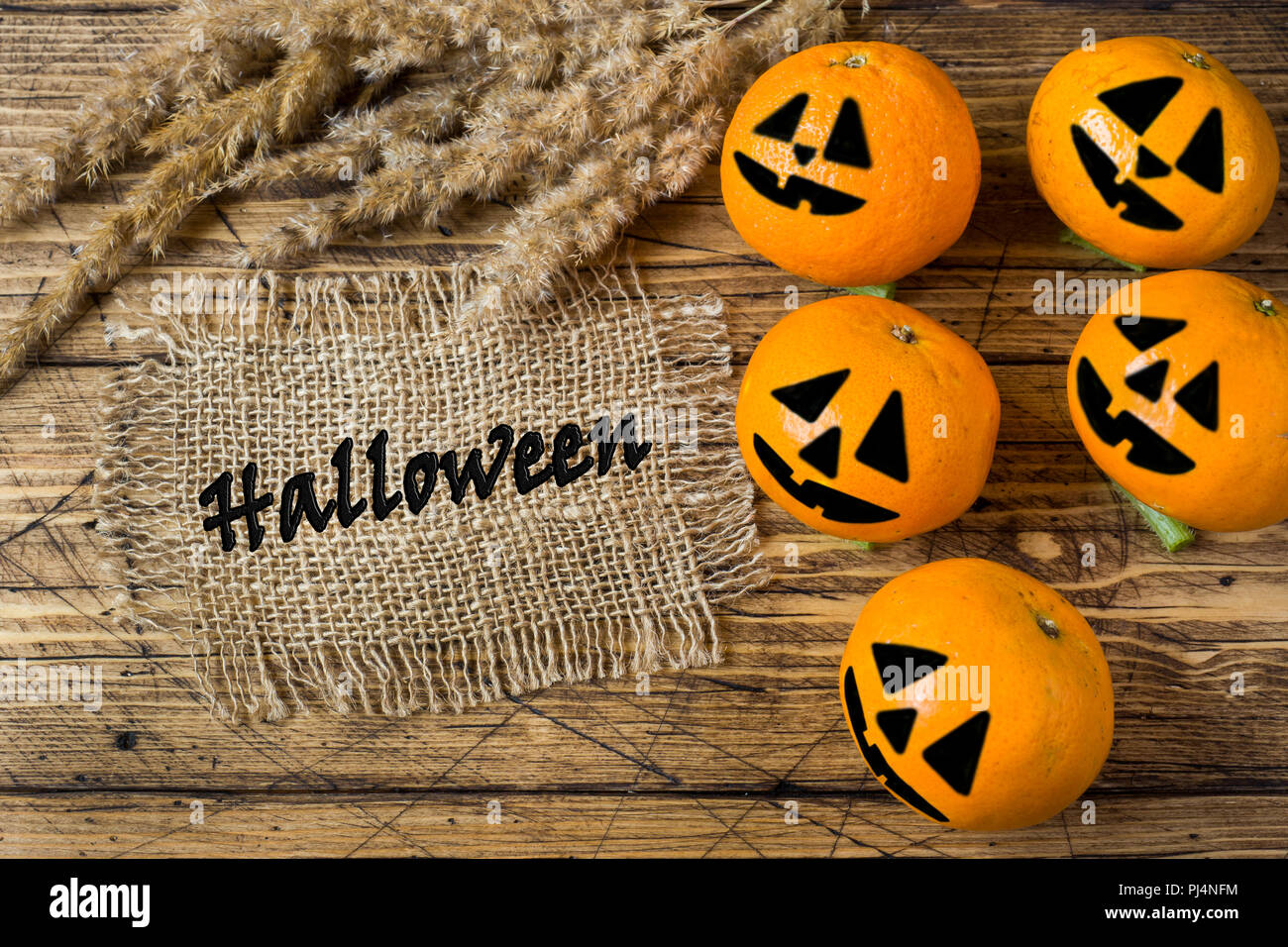 Drawn funny faces on Mandarin oranges for Halloween Stock Photo Alamy