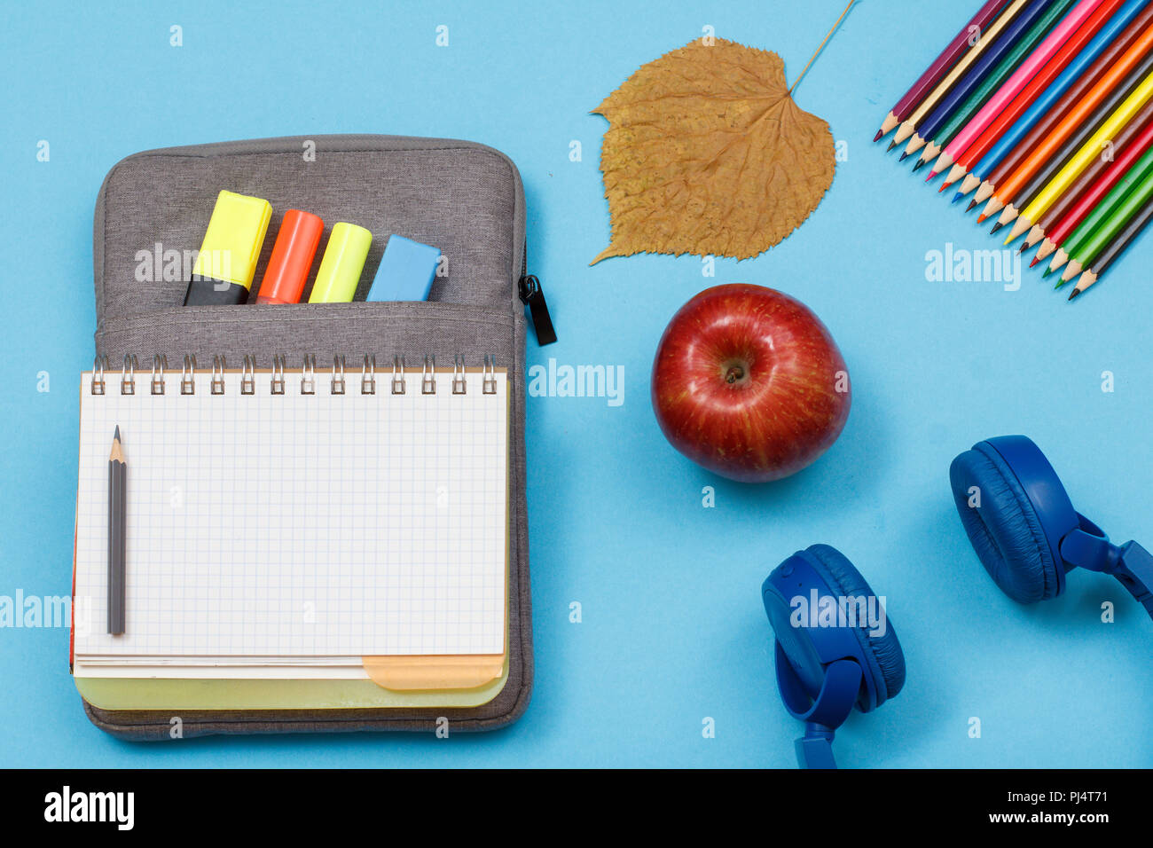 School supplies. Open exercise book on bag-pencil case with color felt ...