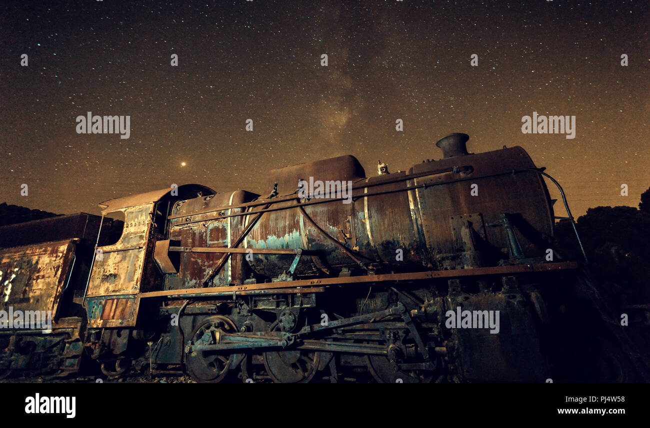 Old locomotive with  and milky way above it in the old train station Stock Photo