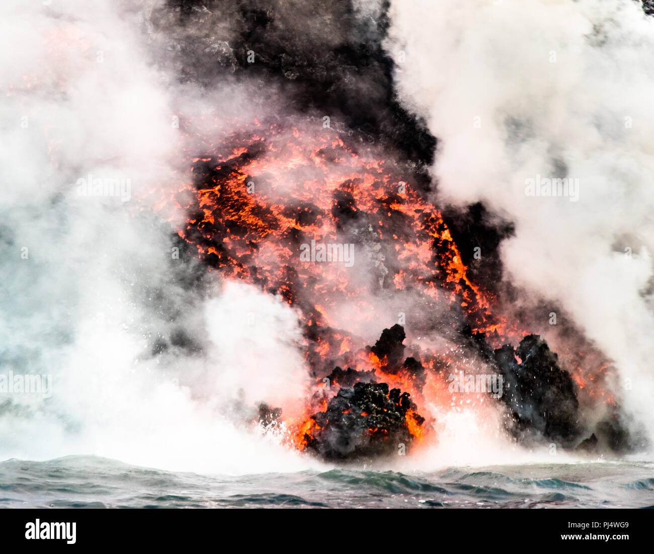Lava flowing into ocean near Punta Moreno from the July 2018 eruption of Cerra Negra on Isabela Island, Galapagos, Ecuador Stock Photo