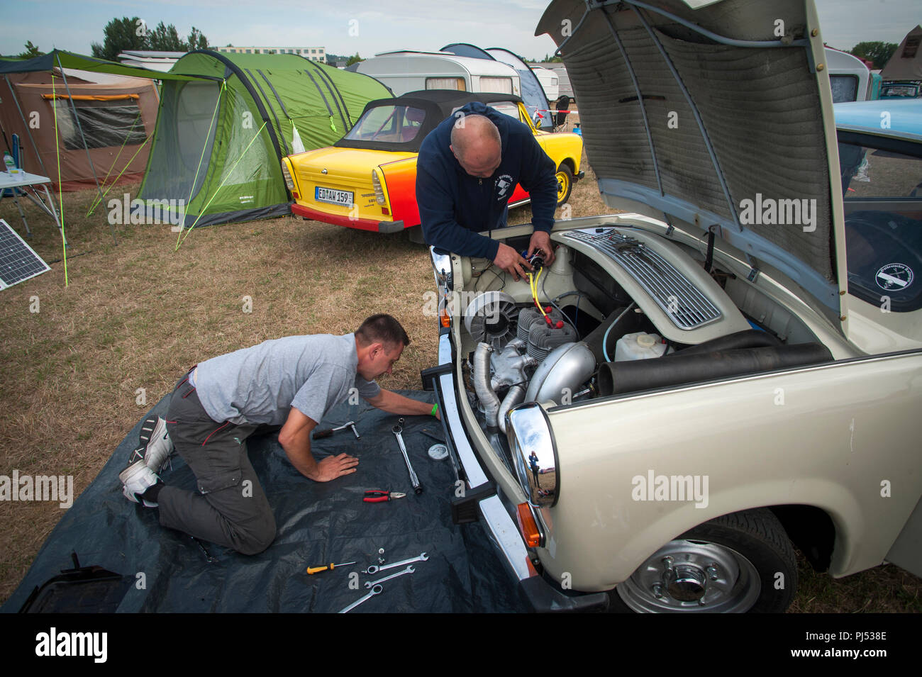 Repairs to a Trabant at the Zwickau Trabant Club Rally in Zwickau, Saxony, Germany. Stock Photo