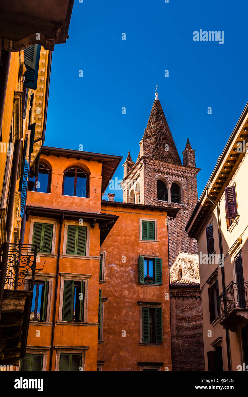 Church tower and buildings against a dark blue sky in Verona, Italy Stock Photo