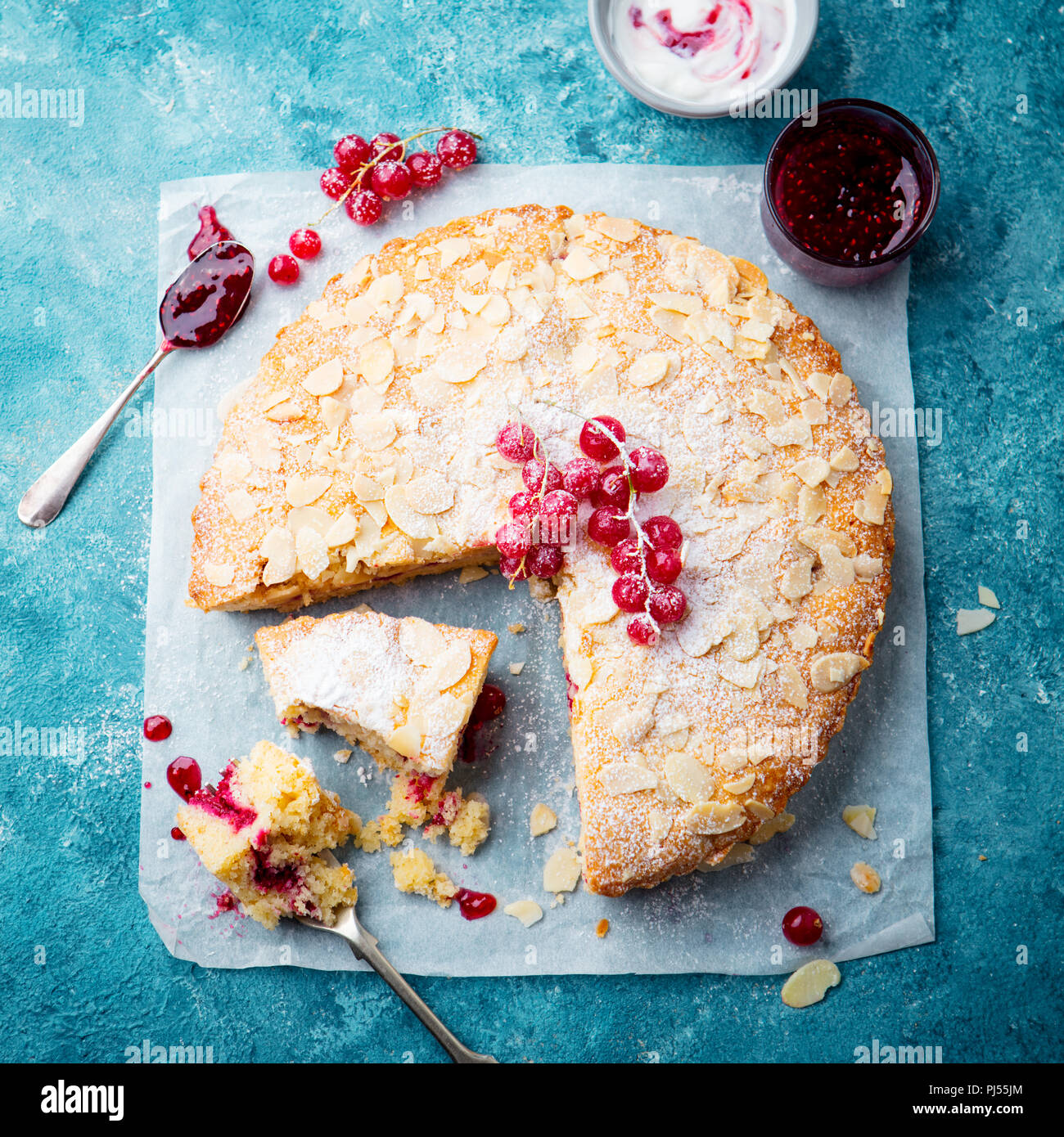 Almond and raspberry cake, Bakewell tart. Traditional British pastry. Blue background. Top view. Stock Photo