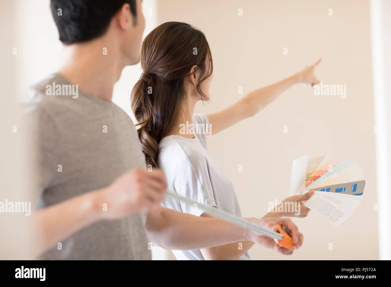 Young couple working on home renovation Stock Photo