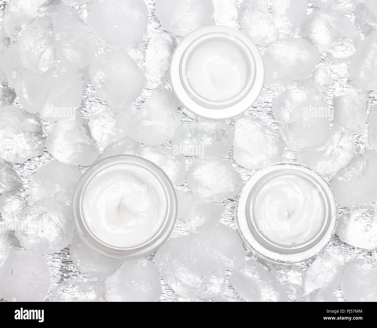 Cooling effect face skincare products. Glass jars of moisturizing cream