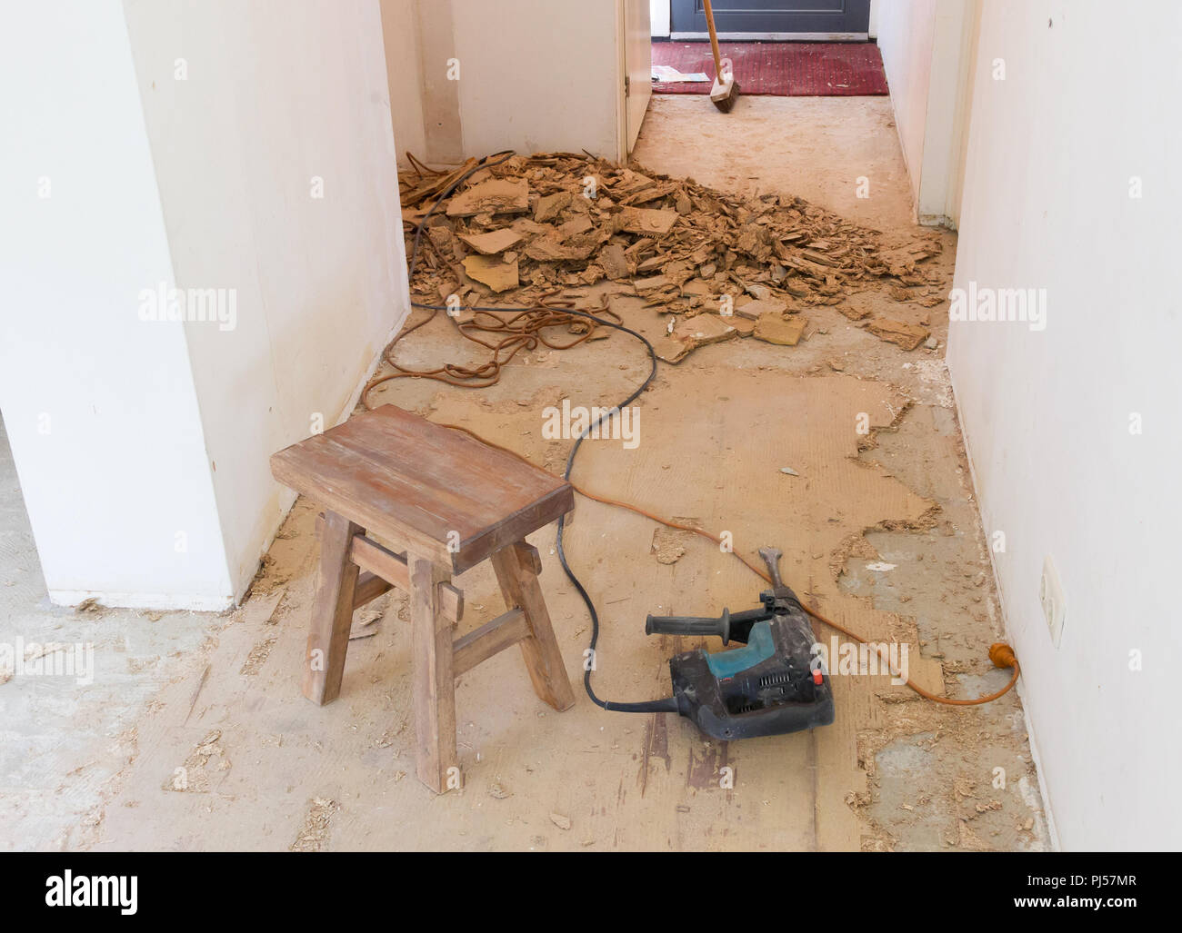 Construction concept Jackhammer, removing chipboard from the floor
