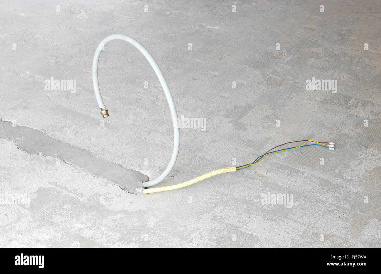 New electricity and gas pipe in a concrete floor - Building a kitchen island Stock Photo
