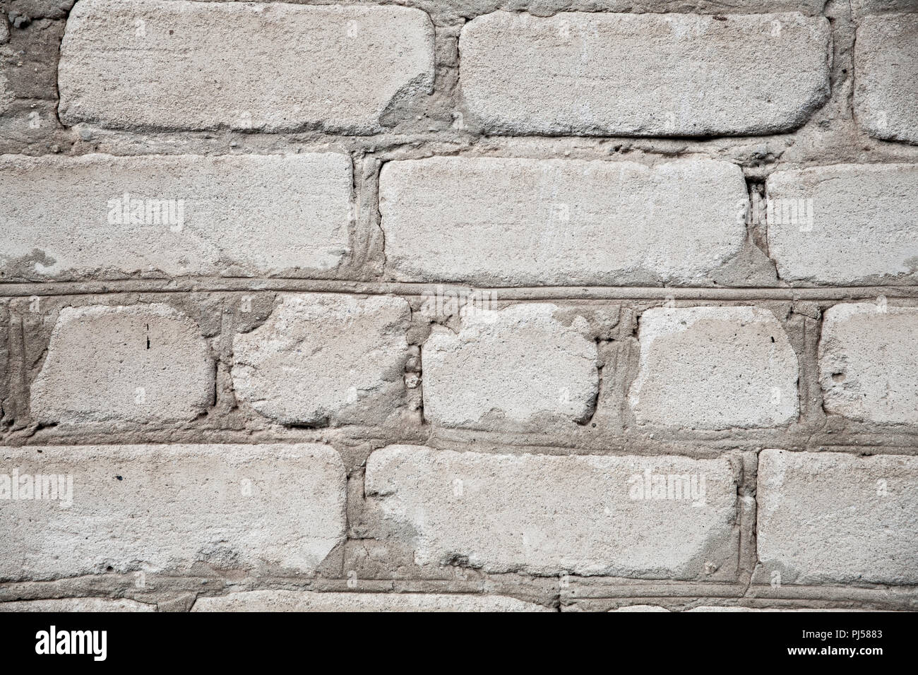 old brick wall of white brick with cement seams texture Stock Photo - Alamy
