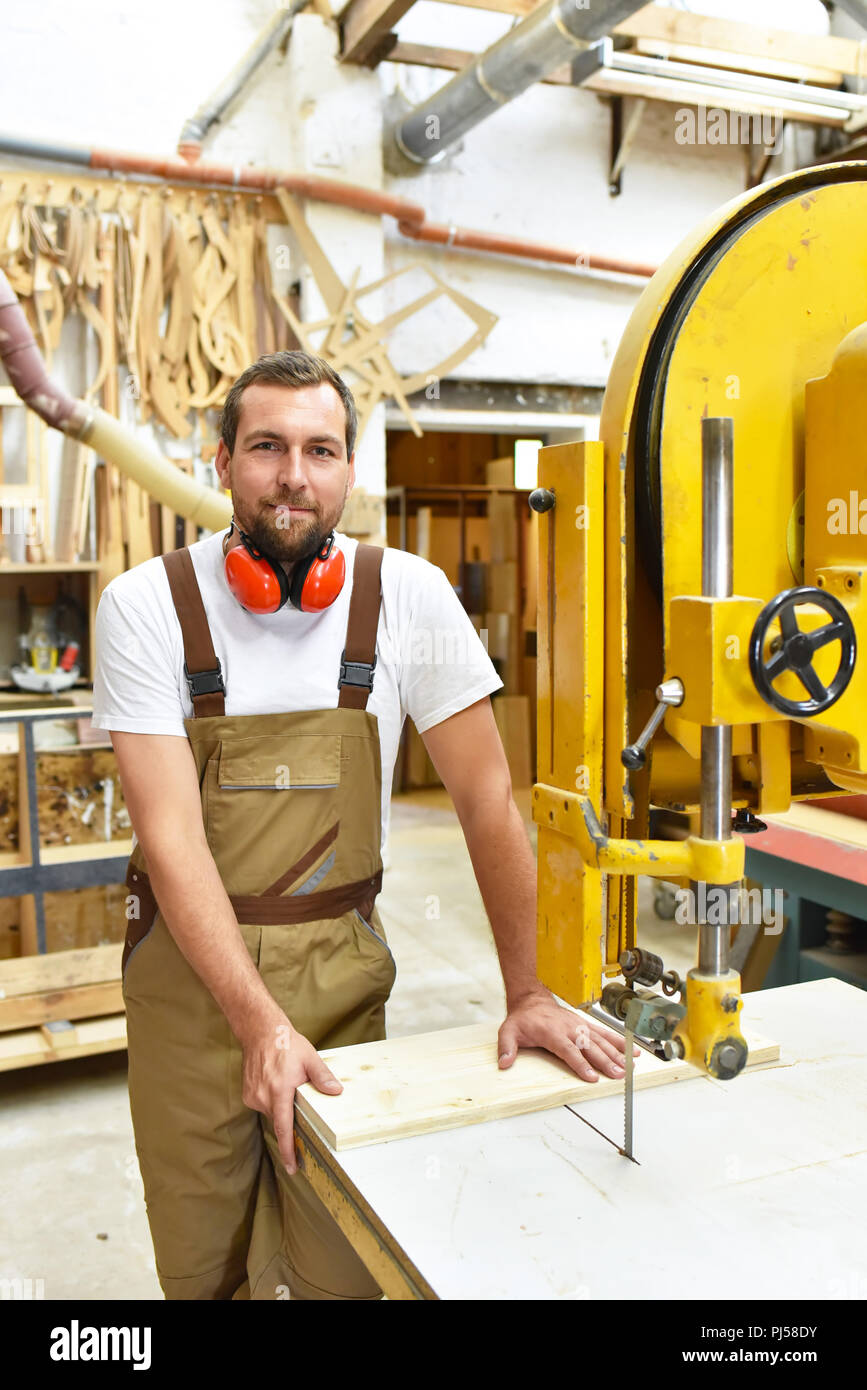 portrait of a worker in a joinery at the workplace - woodworking Stock Photo