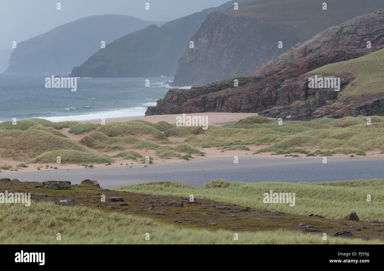 Sandwood Bay, Highlands of Scotland. Remote bay with white sand, dunes and reeds on the far north west coast. Photographed on a very wet day. Stock Photo