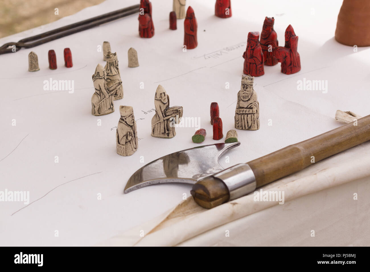 Medieval battle map with Isle of Lewis chess pieces and a battle axe Stock Photo