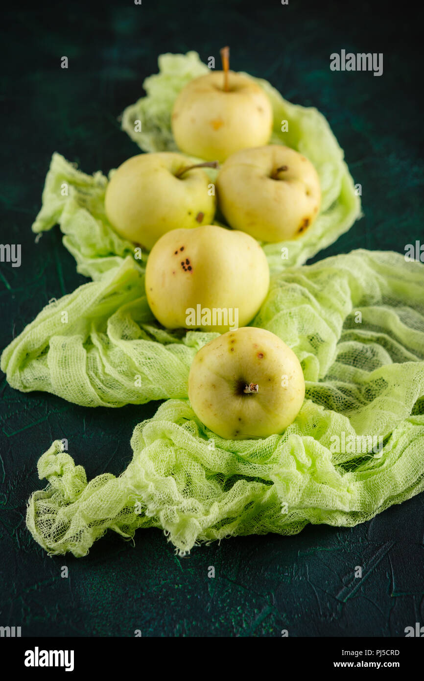 Fresh green apples on dark green background Stock Photo