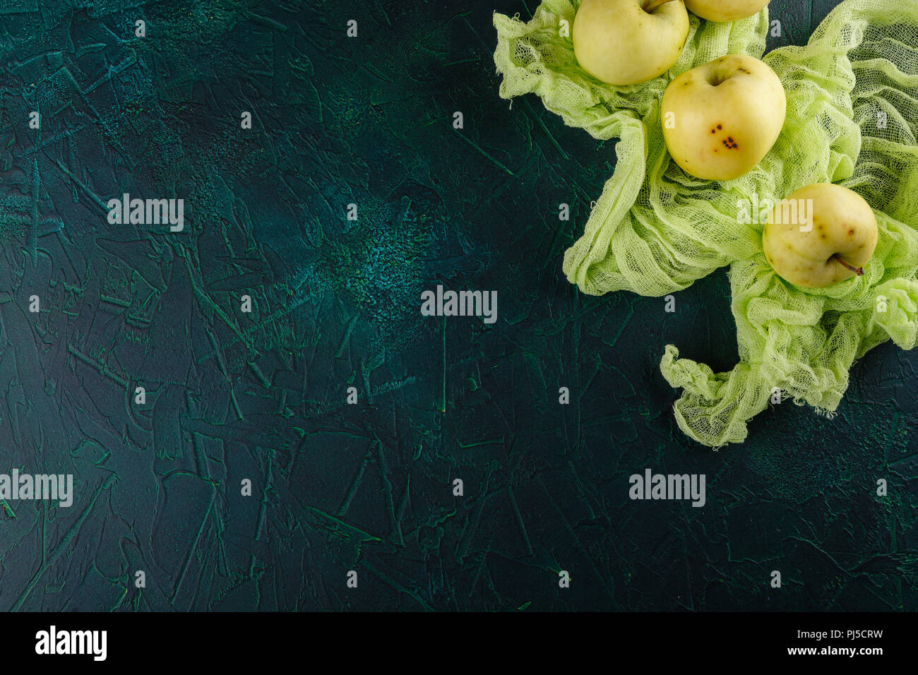Fresh green apples on dark green background Stock Photo