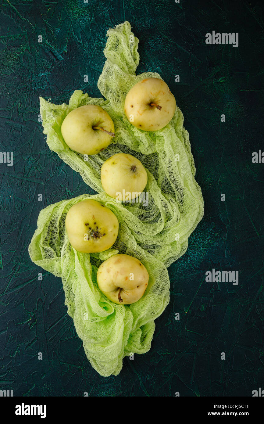 Fresh green apples on dark green background Stock Photo
