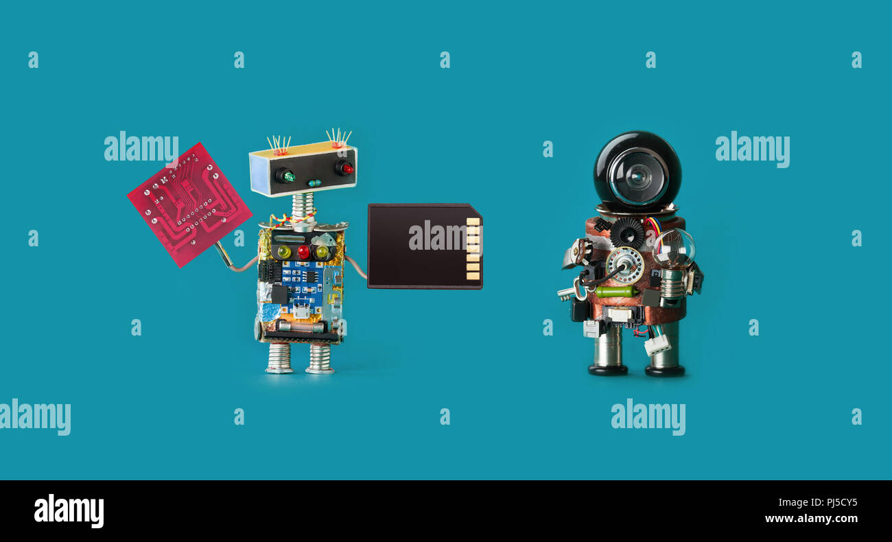 Robotics 4.0 industrial revolution concept. Two robots with circuit board memory card and light bulb on virid color background. Isolated Stock Photo