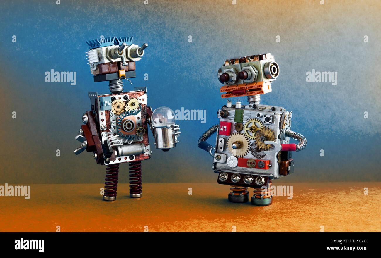 Robots communication, artificial intelligence concept. Two robotic characters with light bulb. Stock Photo