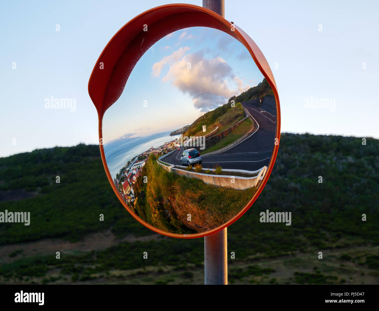 Round traffic mirror reflecting Stock Photo