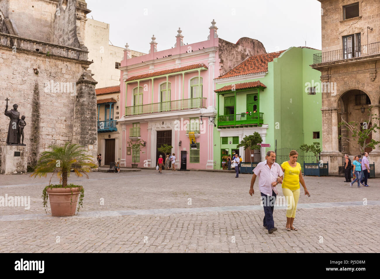 People in Plaza de San Francisco de Asís, restored historic buildings and tourist shops in Old Havana, Cuba Stock Photo