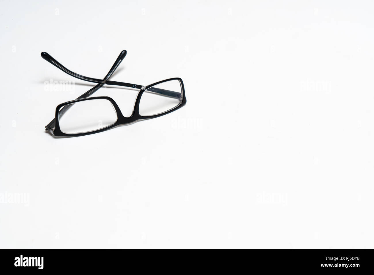 a pair of glasses on a white surface Stock Photo