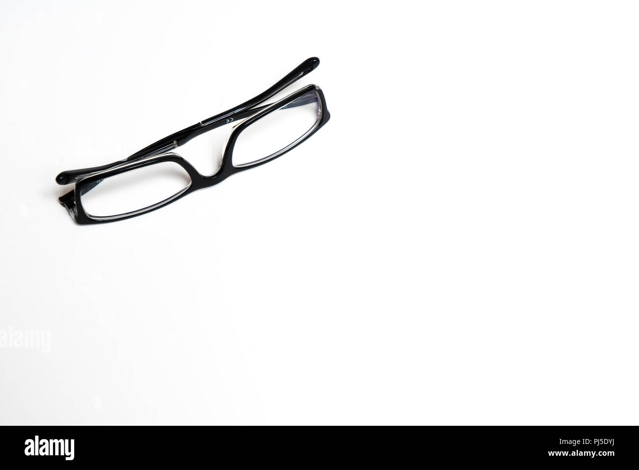 a pair of glasses on a white surface Stock Photo