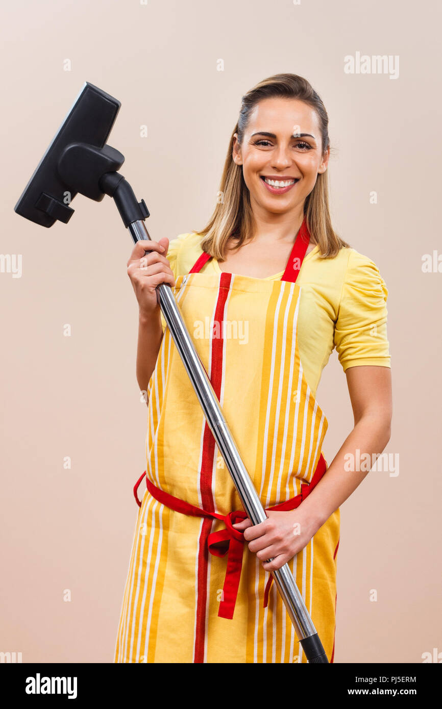 Housewife holding vacuum cleaner Stock Photo Alamy