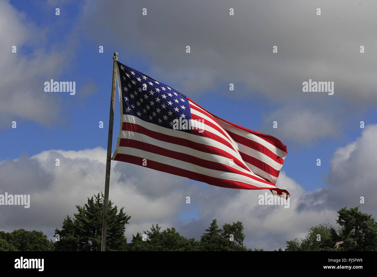 US Flag Flying in the Wind Stock Photo