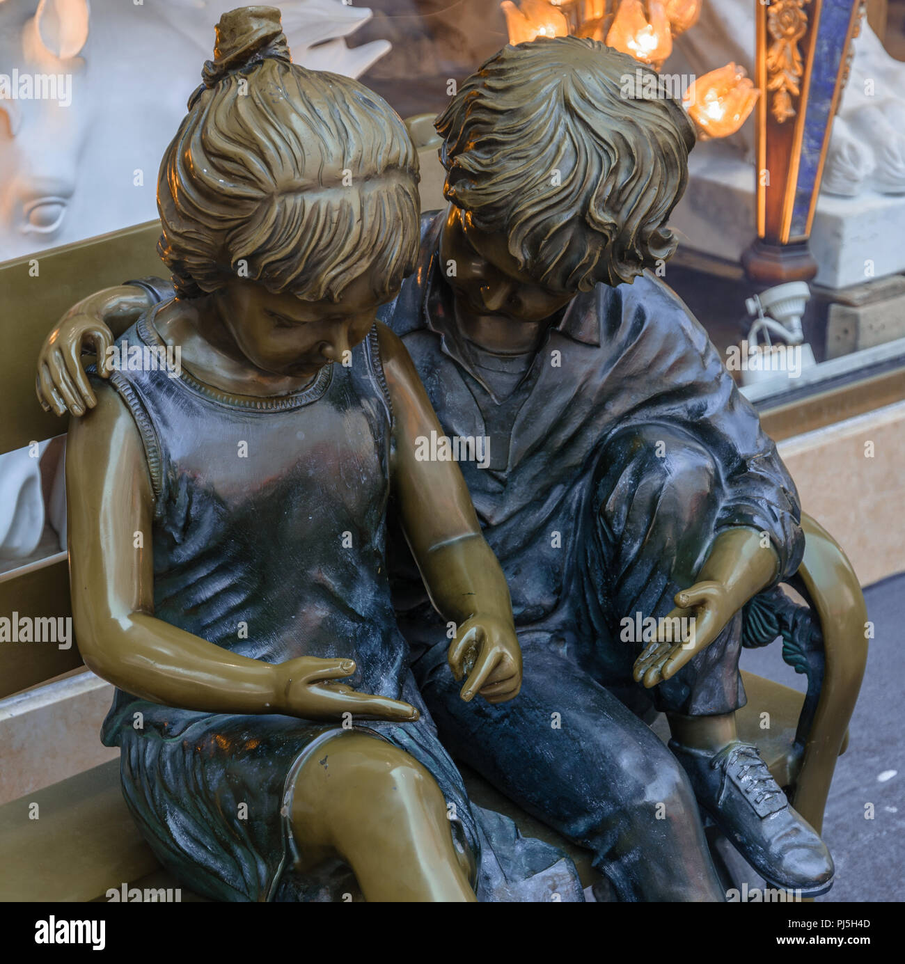 Bronze Sculpture Of Two Children Sitting On A Bench Taken In Chinatown San Francisco Stock Photo