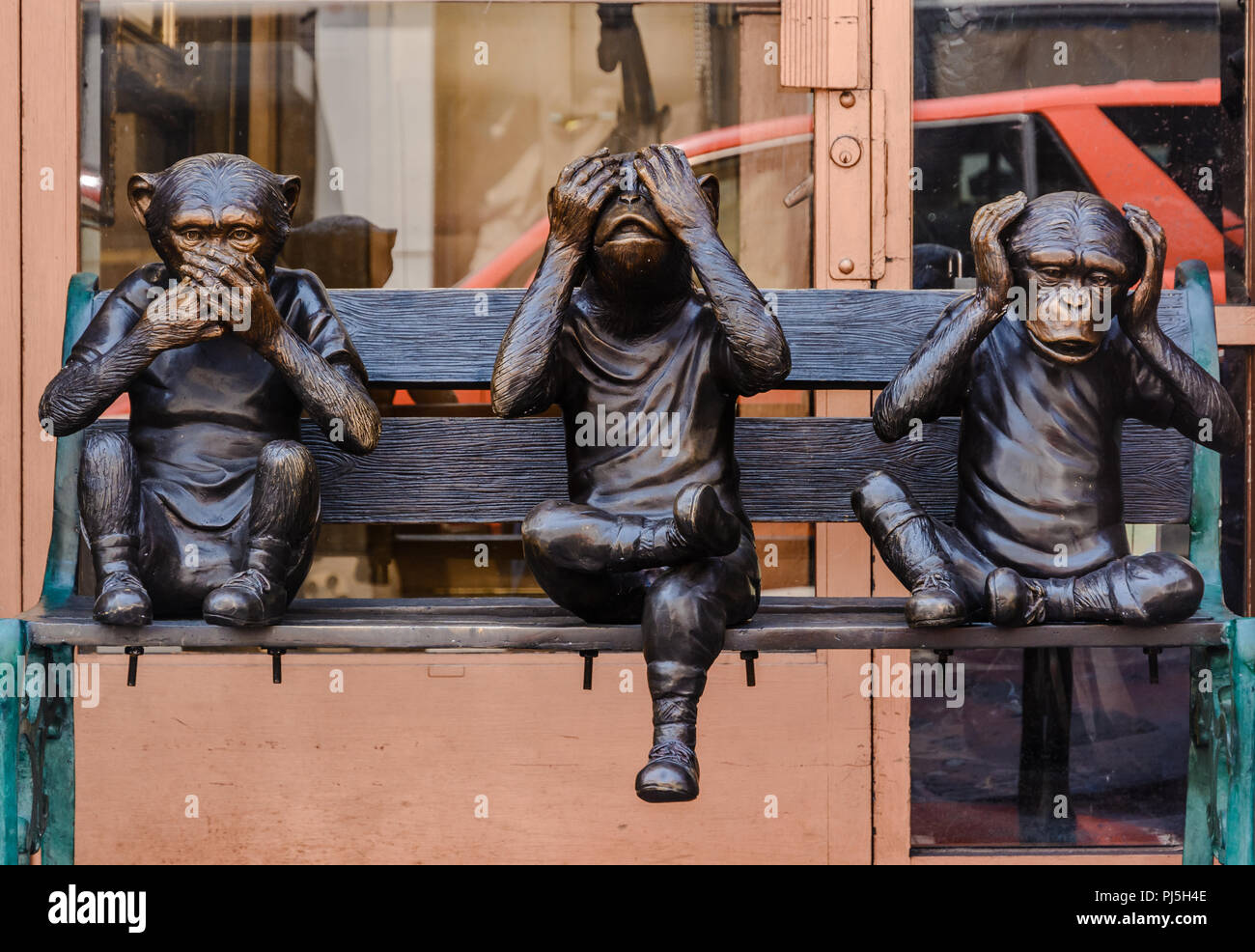 Bronze Sculpture Of Three Wise Monkeys Sitting On A Bench Taken In Chinatown San Francisco Stock Photo