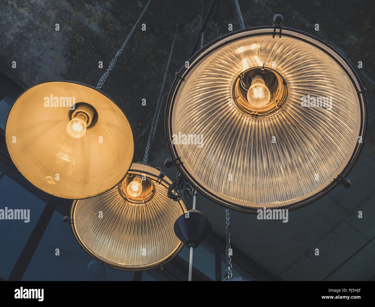 A Group Of Hanging Lights Or Ceiling Lamps On Cement Texture
