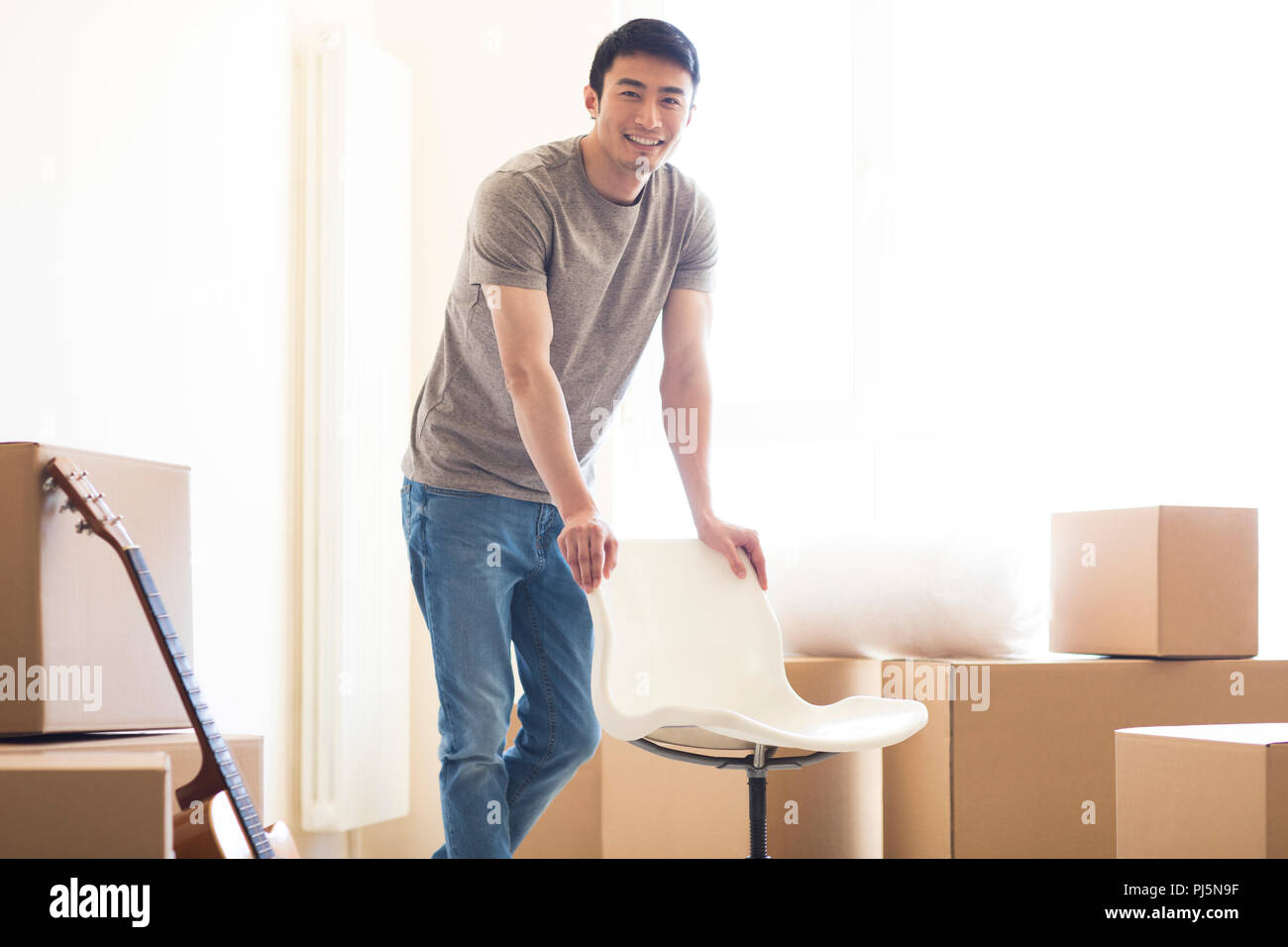 Happy young man moving to a new house Stock Photo Alamy
