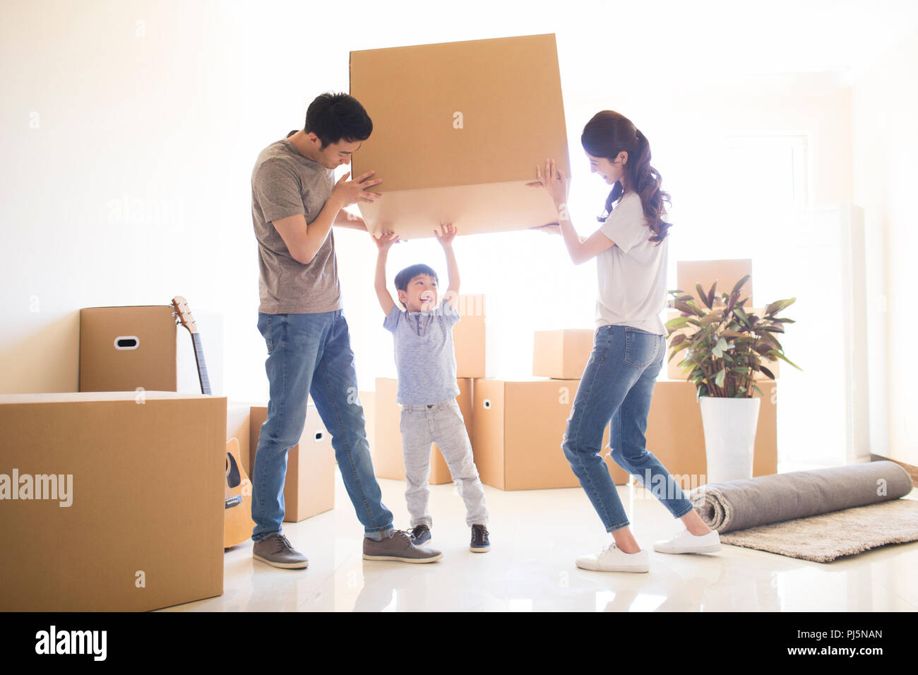 Happy young family moving to a new house Stock Photo - Alamy