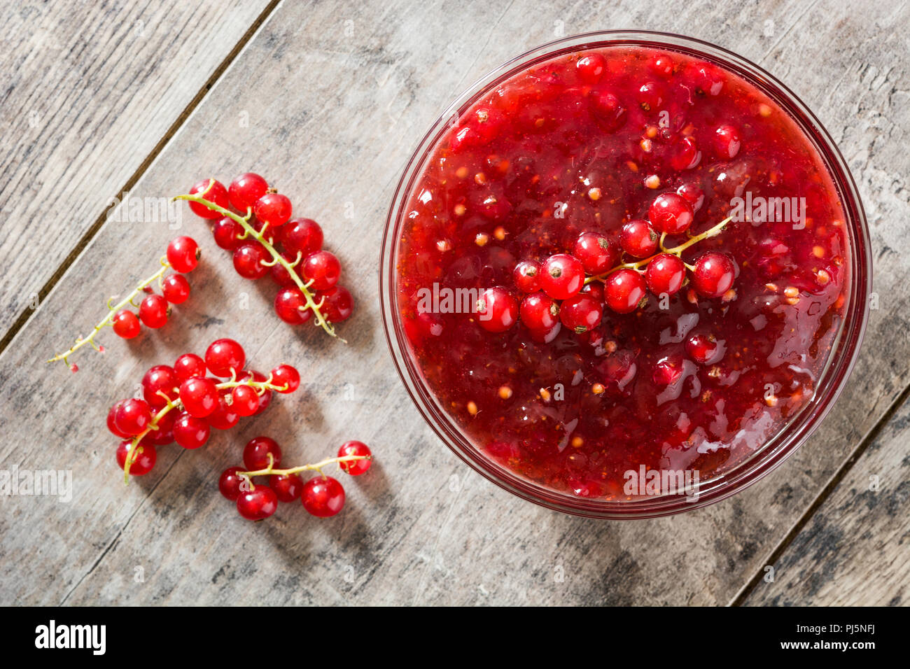 Cranberry sauce in bowl for Thanksgiving dinner on wooden table. Top view Stock Photo