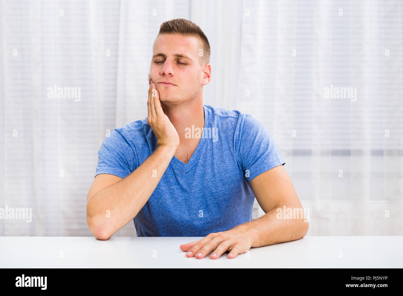 Young man is having toothache. Stock Photo