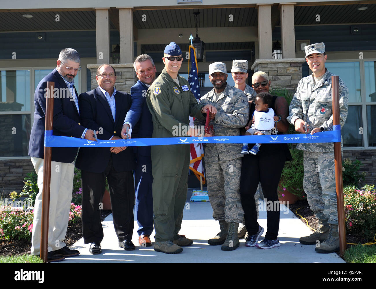 Members of Team McConnell and Corvias cut the ribbon for the new Red
