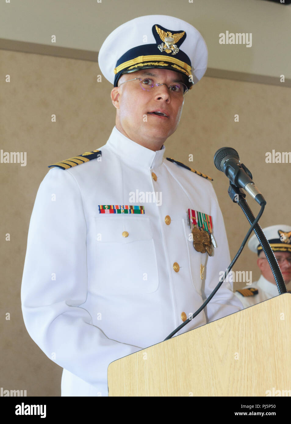 Captain John Barresi, commander of the Facilities Design and Construction Center (FDCC) addresses members of his new command during the change of command ceremony Aug. 24, 2018 in Norfolk, Virginia. The FDCC is responsible for the oversight of the design and construction of facility projects including housing, aircraft hangers and small boat stations. (U.S. Coast Guard photo by Auxiliarist Andy Winz/Released) Stock Photo