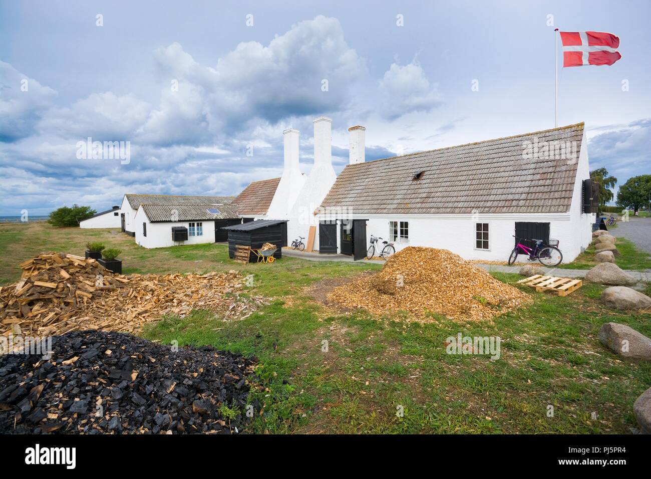 Old traditional smokehouse characteristic chimneys in Hasle, Bornholm, Denmark. This is the place, where you can taste the most popular dish on the is Stock Photo