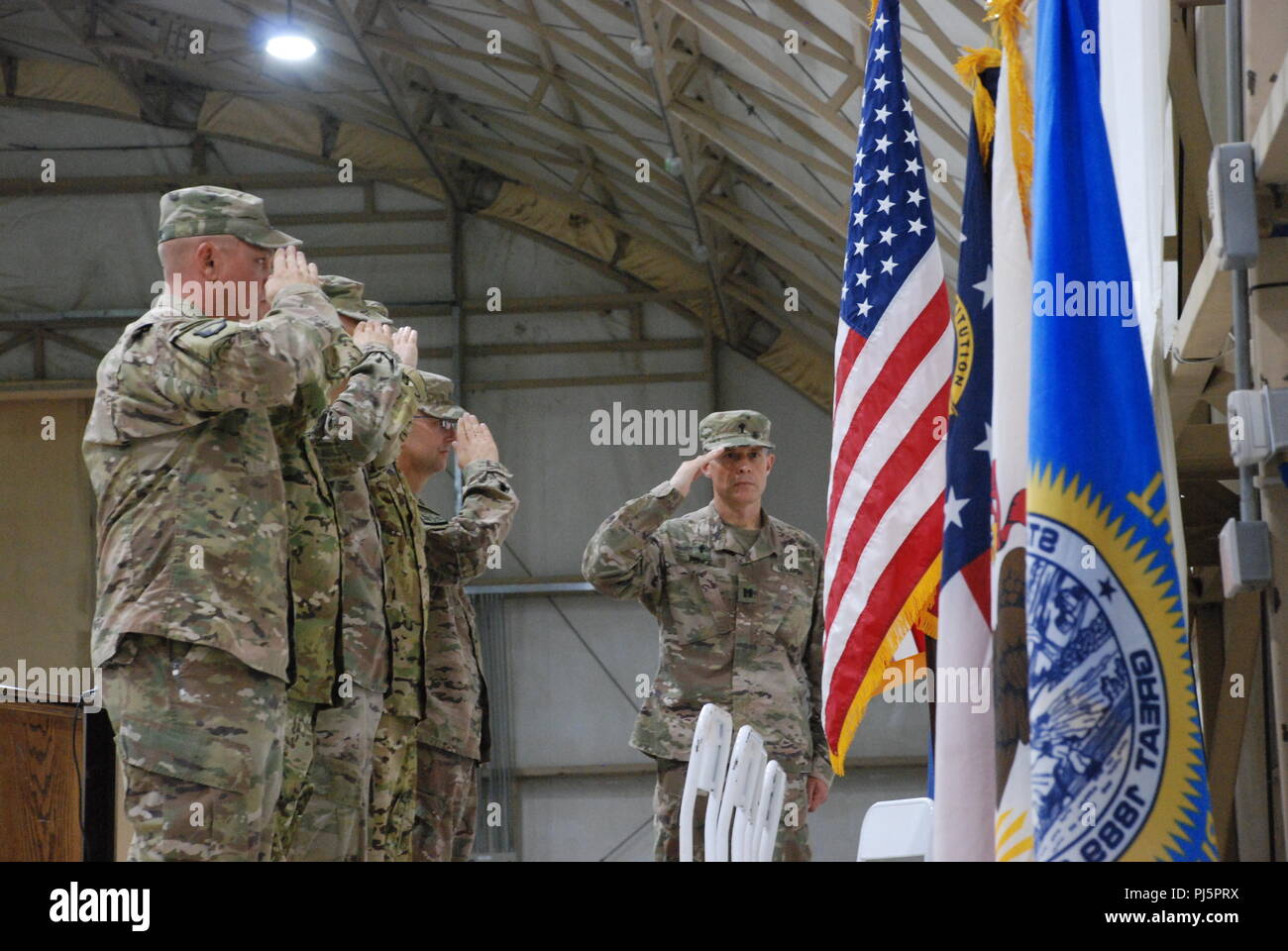 CAMP BUEHRING, Kuwait - Leaders assigned to the 248th Aviation Support Battalion and 935th ASB render a salute during the playing of the national anthem at a transfer of authority ceremony Aug. 26 at Camp Buehring, Kuwait. The ceremony signified the successful completion of the units nine-month deployment to the Middle East as the 935th ASB assumes the command of the mission. (U.S. Army photo by Sgt. Billie Thompson/935 ASB) Stock Photo