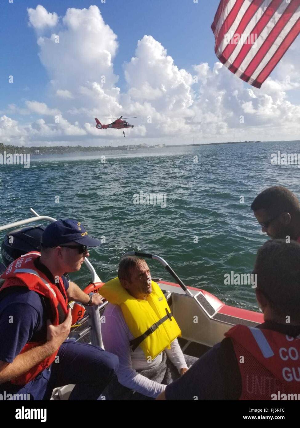 Robert Vonnegut sits aboard a Coast Guard Station Islamorada 33-foot Special Purpose Craft-Law Enforcement boat after being rescued by the crewmembers Aug. 27, 2018 near Tavernier, Florida. The boatcrew and a Coast Guard Air Station Miami MH-65 helicopter crew went searching for Vonnegut after watchstanders at Coast Guard Sector Key West received a report from the son of Vonnegut stating his father departed from Sunrise Drive and hadn't returned. (Coast Guard Photo) Stock Photo