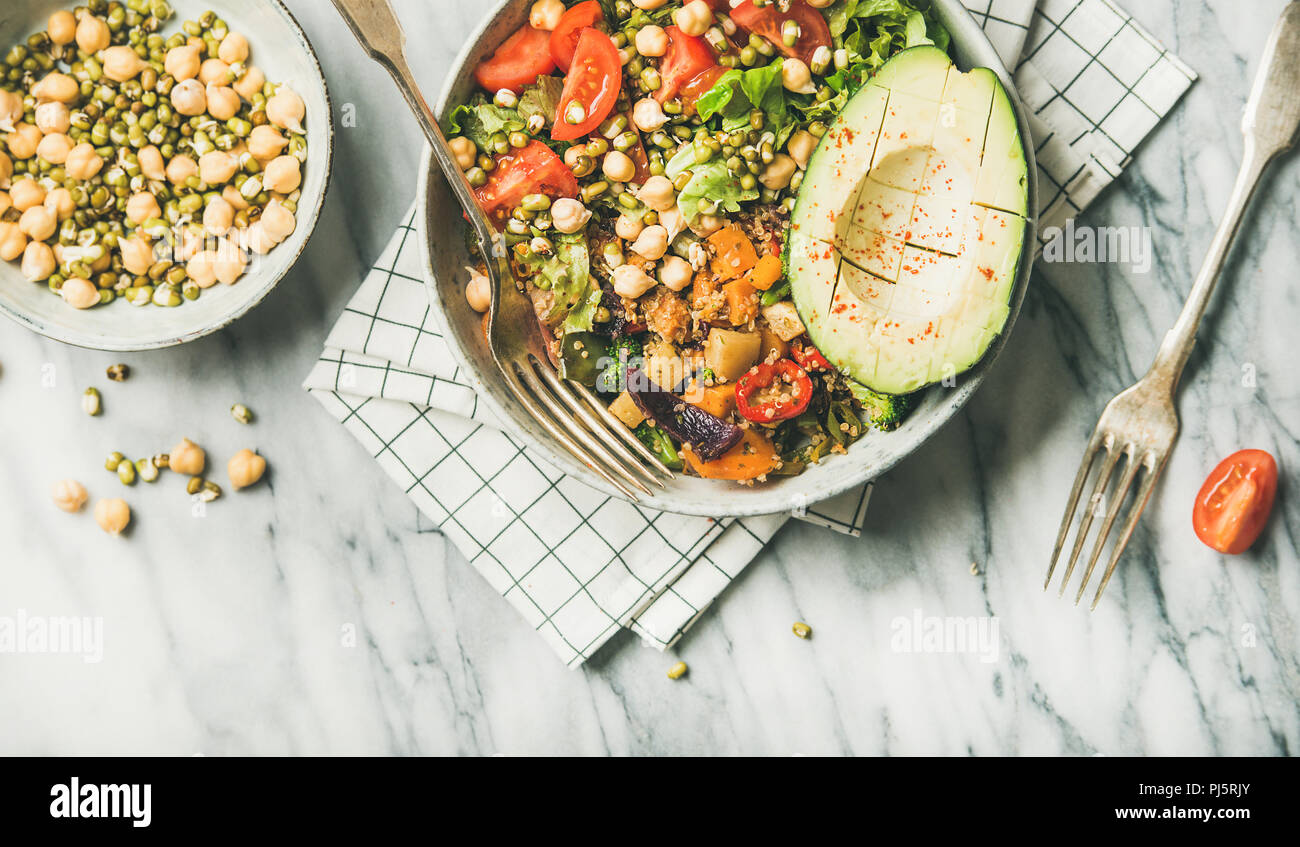 Vegan lunch bowl. Flatlay of dinner with avocado, grains, beans