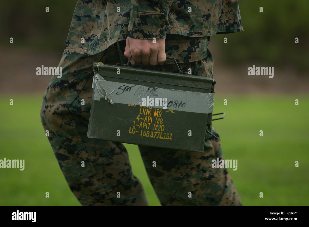 A U.S. Marine with 1st Tank Battalion, carries ammo cans during the