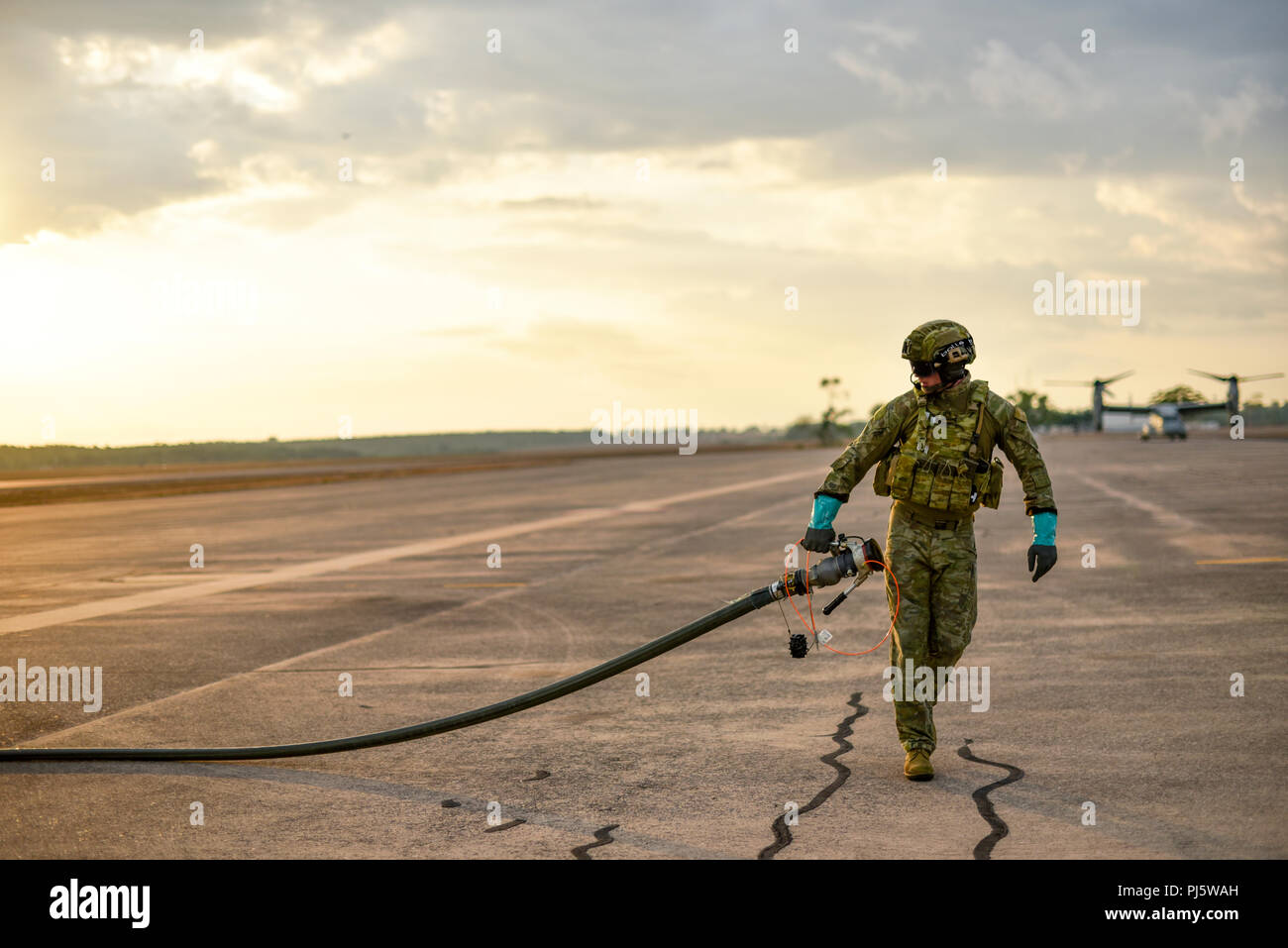 A member of the Australian Army prepares the fuel line from an Australian Defence Force C130J