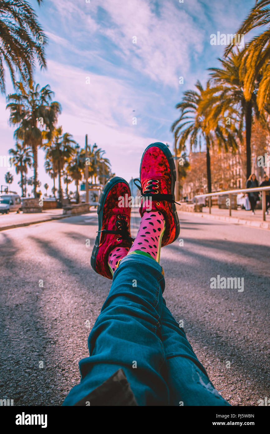 Happy socks on the middle of the street in Barcelona, Spain, with amazing view and palm trees on the sides Stock Photo