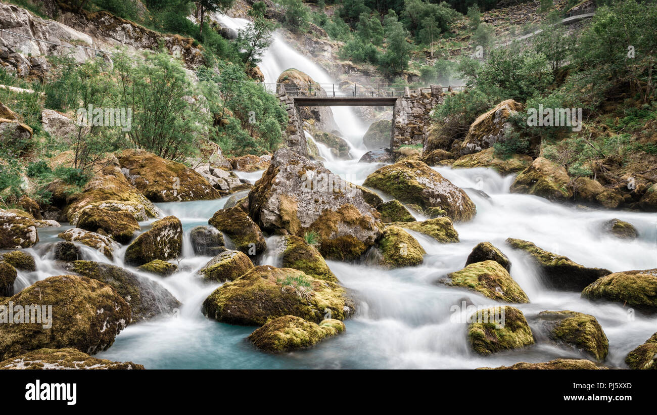Bridge over water flowing from the Briksdal glacier in Jostedalsbreen National Park, Norway Stock Photo