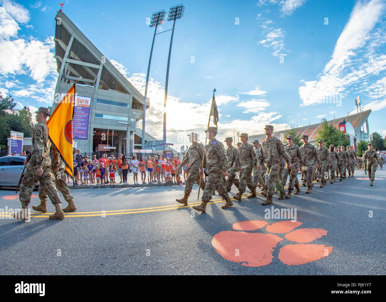 A formation of Clemson University Army ROTC cadets marches past