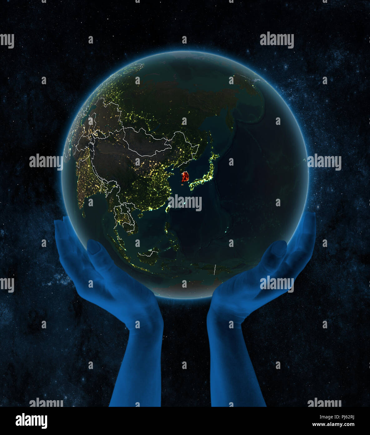 South Korea on night planet Earth with visible country borders in hands ...