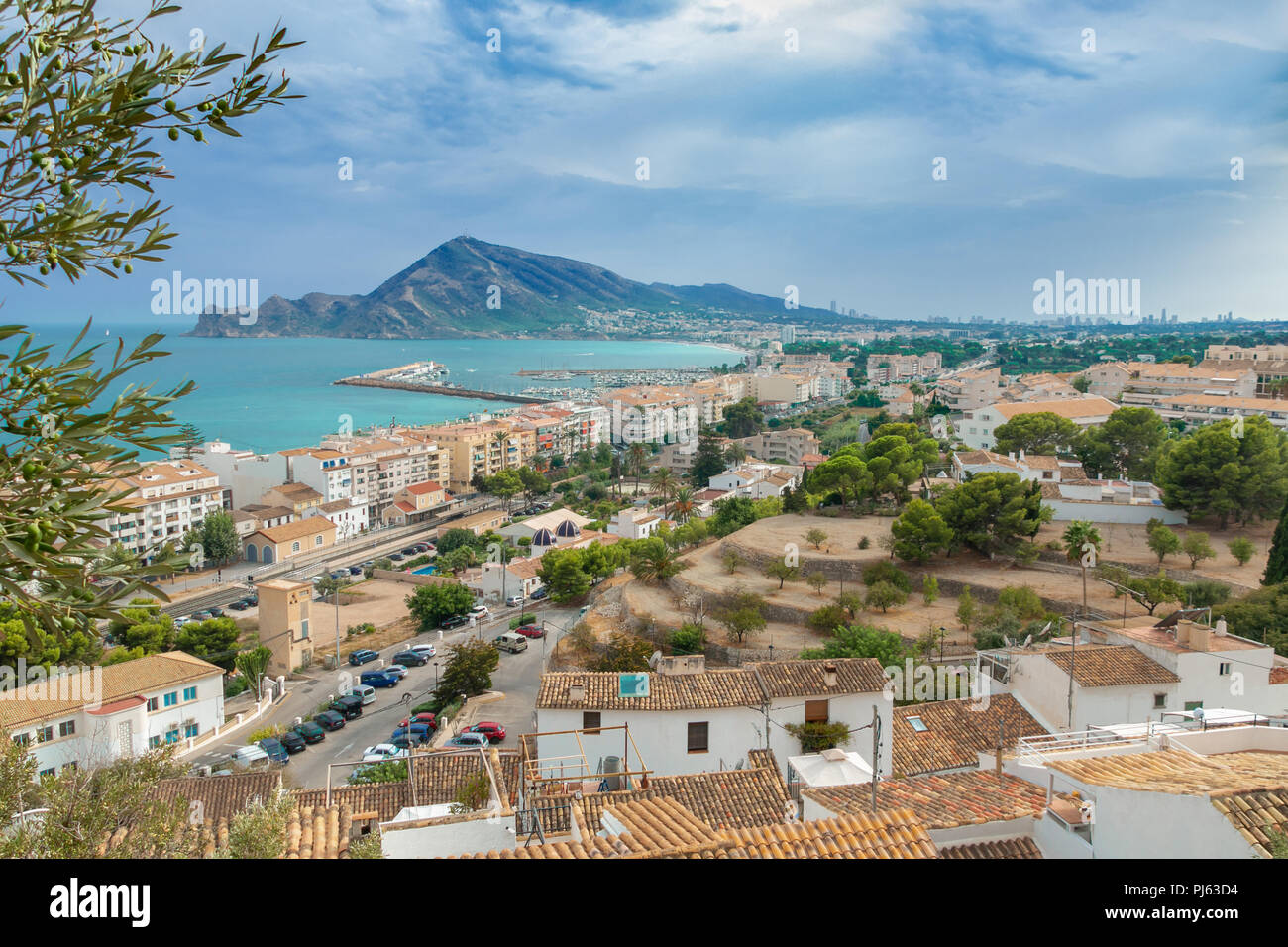 View of the orange roofs of houses in the town of Altea, Valencia, Spain. In the distance, the Mediterranean, the Mount of Mount Ifach in Calpe in Val Stock Photo