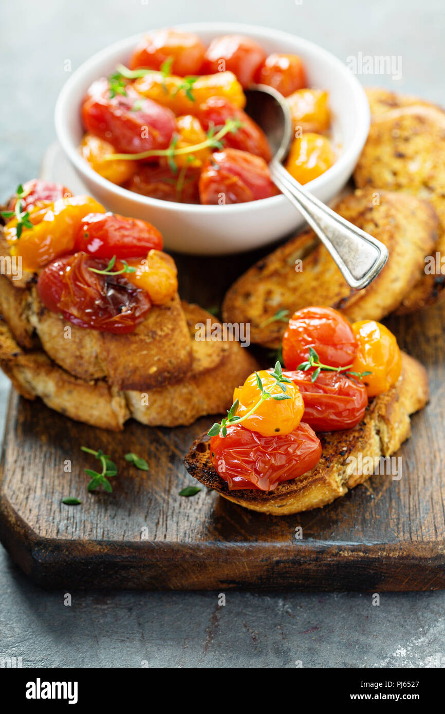 Roasted tomatoes bruschetta with thyme on garlic bread Stock Photo Alamy
