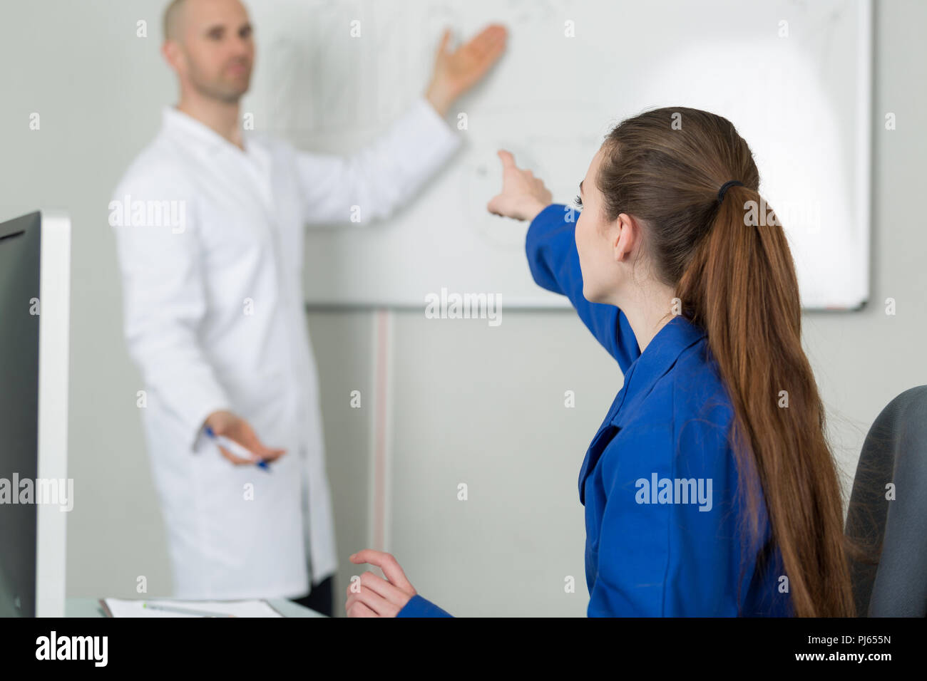 female elementary pupil in computer class with teacher Stock Photo