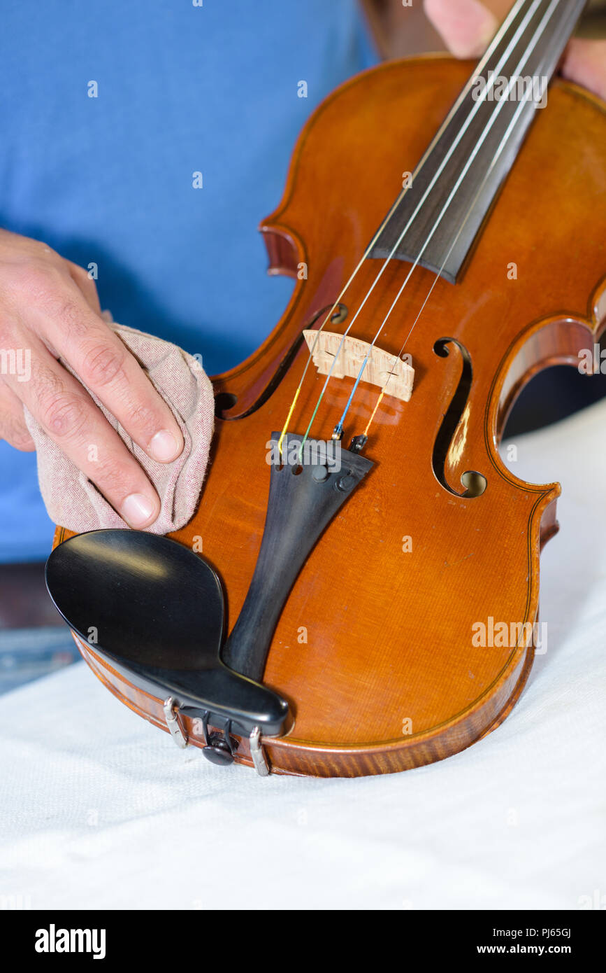 polishing the violin Stock Photo Alamy
