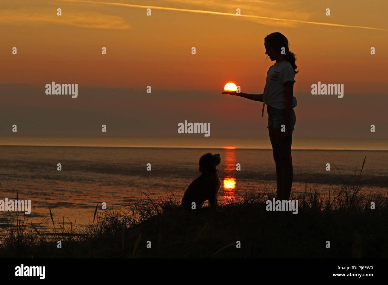 Hunstanton, Norfolk. 4th Sept 2018. UK Weather A young girl and her dog enjoy the end of a warm Hunstanton, Norfolk. 4th Sept 2018. UK Weather A young girl and her dog enjoy the end of a warm